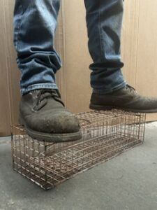 muscular figure standing on one of our traps